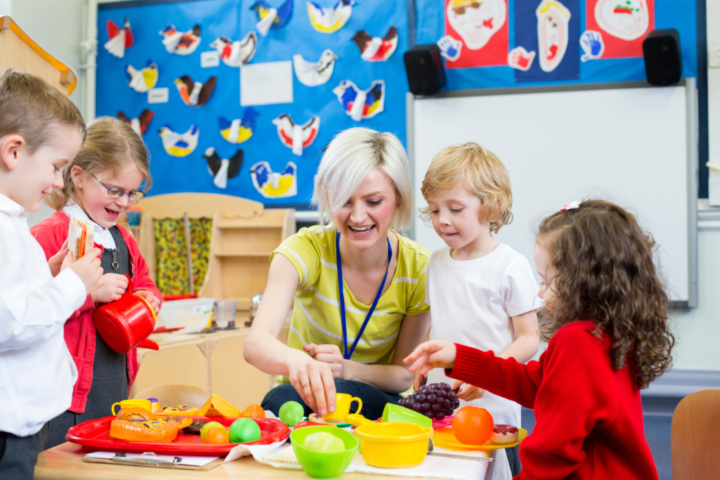 Image of nursery staff member working with children, within marketing to nurseries blog post.